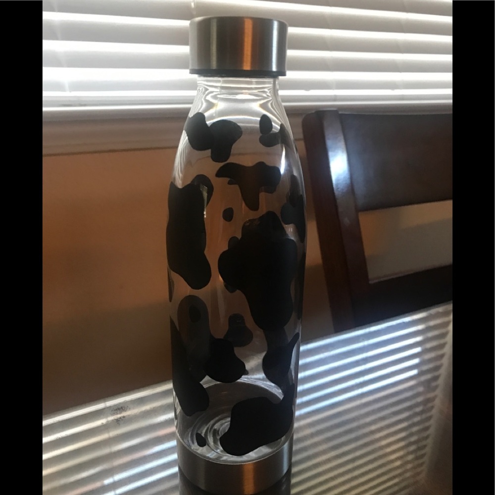 Beautiful cow print on clear water bottle.